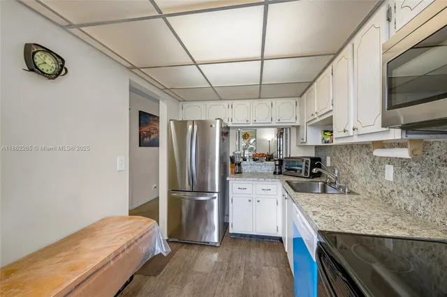 a kitchen with a refrigerator and a sink
