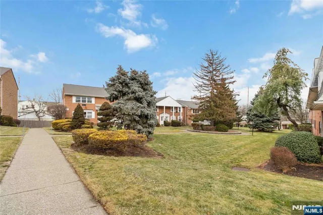 a view of swimming pool outdoor seating and trees in the background