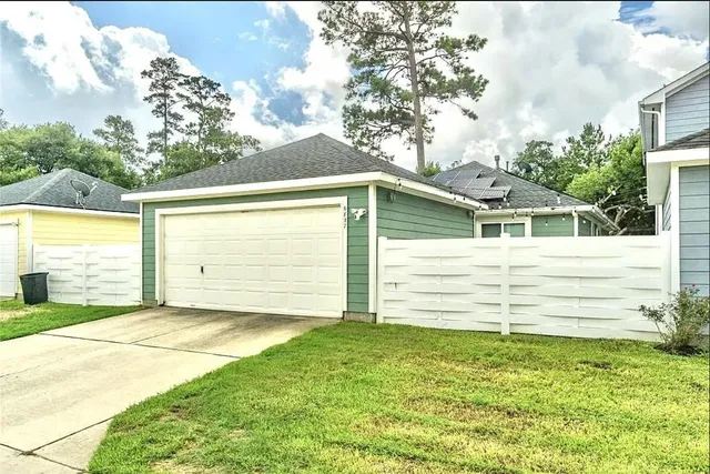 a view of a backyard with a large tree