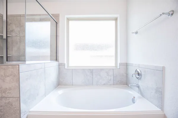 a bathroom with a glass shower door