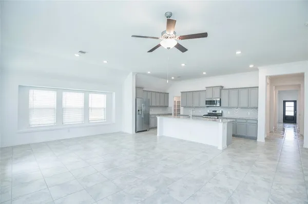 a kitchen with stainless steel appliances a sink stove and refrigerator
