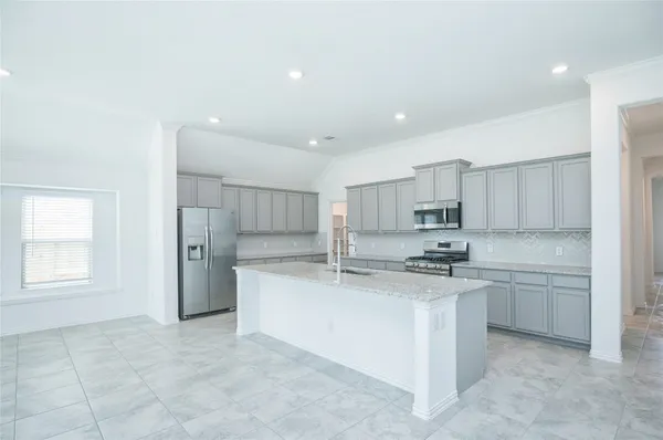 a kitchen with stainless steel appliances granite countertop a sink stove and cabinets