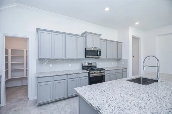 a kitchen with granite countertop a sink and a window