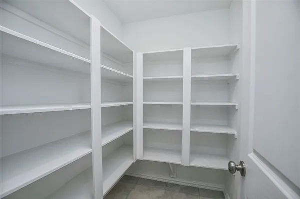 a view of a hallway with a white walls and stairs