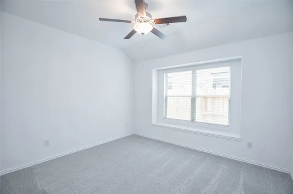 an empty room with a ceiling fan and a ceiling fan