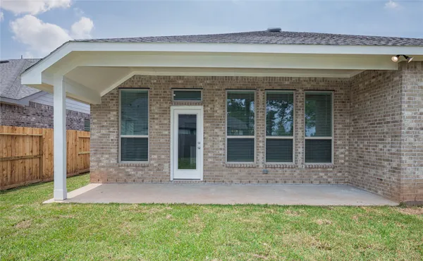 a bathroom with a granite countertop sink a mirror and a bathtub