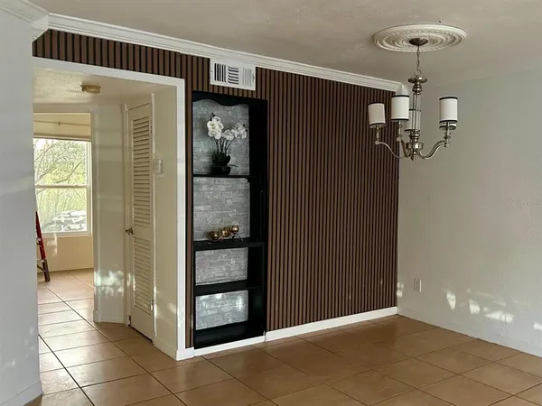 a view of a hallway with wooden shelves