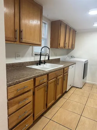 a kitchen with stainless steel appliances granite countertop a sink and cabinets