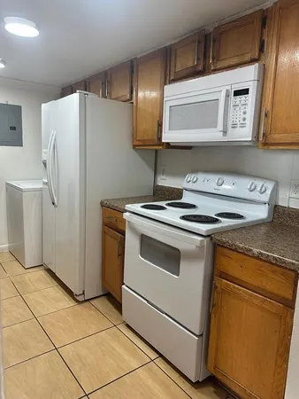 a kitchen with stainless steel appliances cabinets and a counter top space