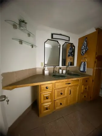 a spacious bathroom with a granite countertop sink and a mirror