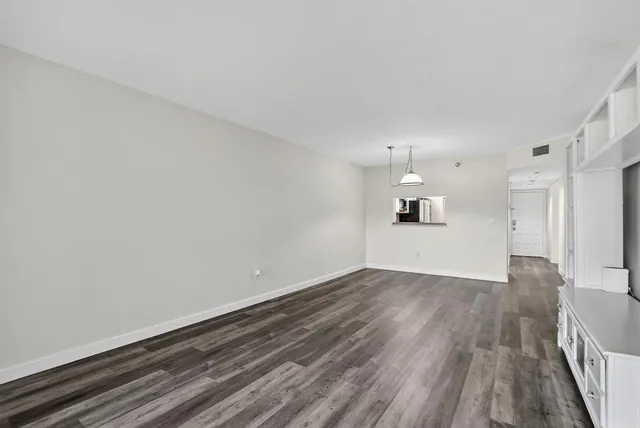a view of a room with wooden floor and windows