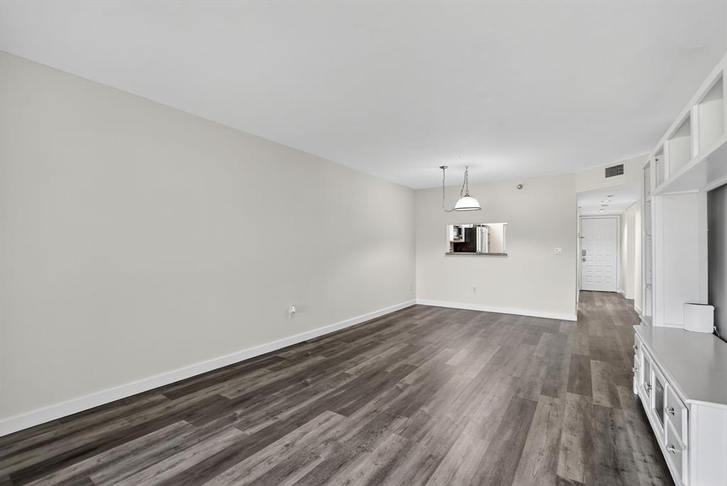 260 Northwest 67th Street, Unit A104 Boca Raton, FL 33487 - Photo 13 of 43 a view of a room with wooden floor and windows