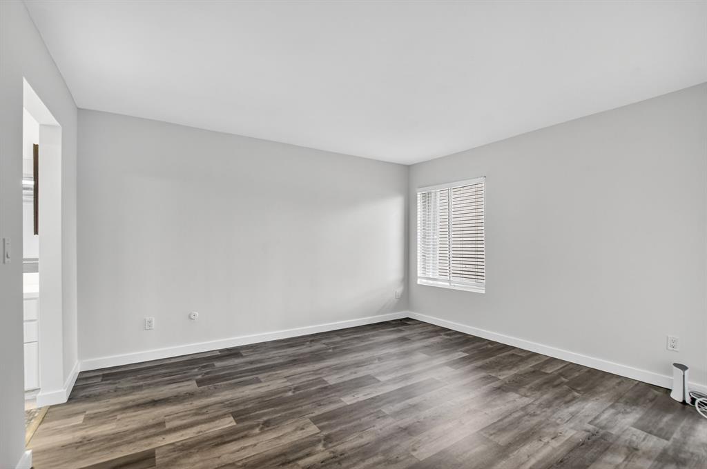 260 Northwest 67th Street, Unit A104 Boca Raton, FL 33487 - Photo 14 of 43 a view of a room that has wooden floor and window in it