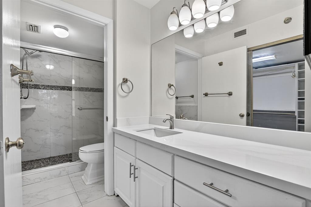 260 Northwest 67th Street, Unit A104 Boca Raton, FL 33487 - Photo 17 of 43 a bathroom with a sink a toilet and a large mirror