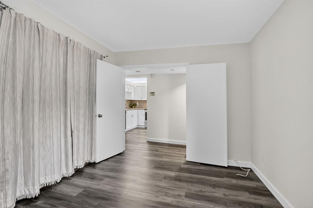 260 Northwest 67th Street, Unit A104 Boca Raton, FL 33487 - Photo 22 of 43 a view of a hallway with wooden floor