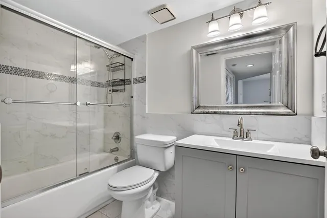 a bathroom with a toilet a sink and bathtub
