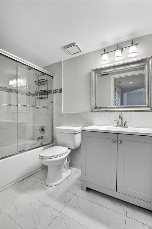 260 Northwest 67th Street, Unit A104 Boca Raton, FL 33487 - Photo 24 of 43 a bathroom with a toilet a sink and bathtub