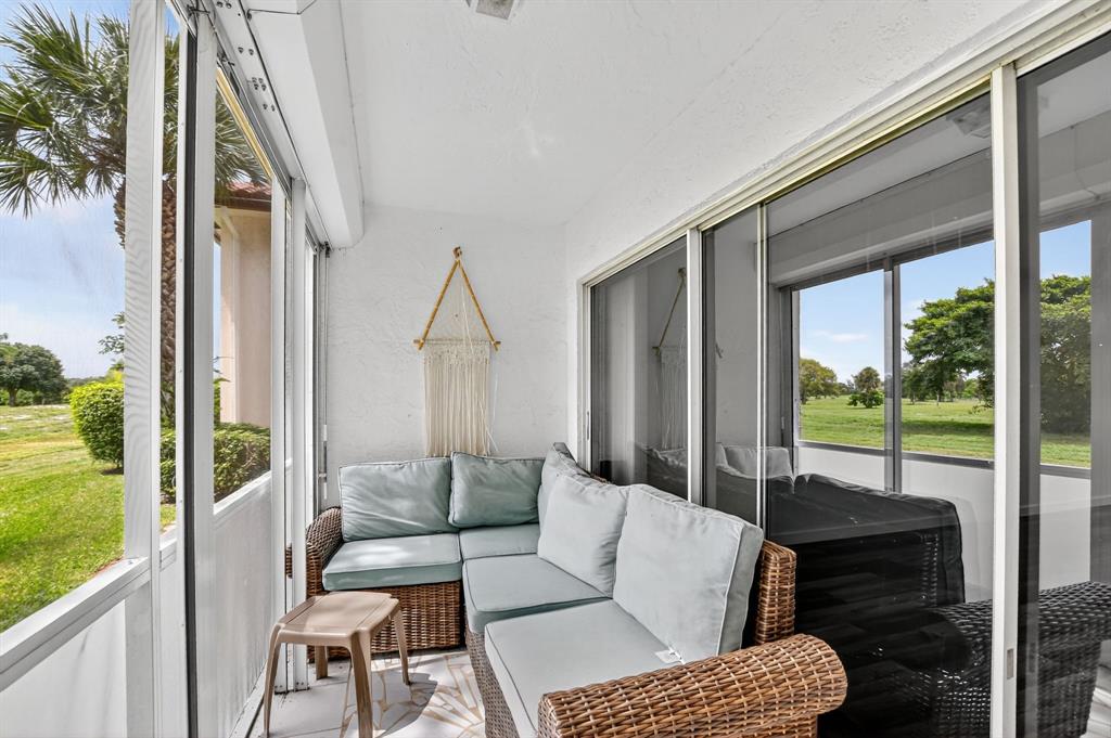 260 Northwest 67th Street, Unit A104 Boca Raton, FL 33487 - Photo 28 of 43 a outdoor living space with furniture and garden view