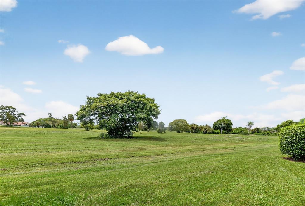 260 Northwest 67th Street, Unit A104 Boca Raton, FL 33487 - Photo 30 of 43 a view of a golf course with a lake
