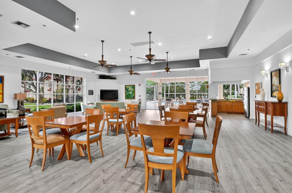 260 Northwest 67th Street, Unit A104 Boca Raton, FL 33487 - Photo 34 of 43 a view of a dining room with furniture window and wooden floor
