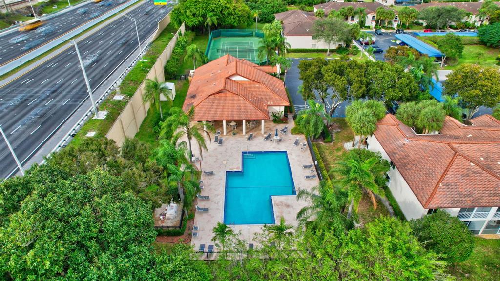 260 Northwest 67th Street, Unit A104 Boca Raton, FL 33487 - Photo 40 of 43 an aerial view of house with swimming pool outdoor seating and yard