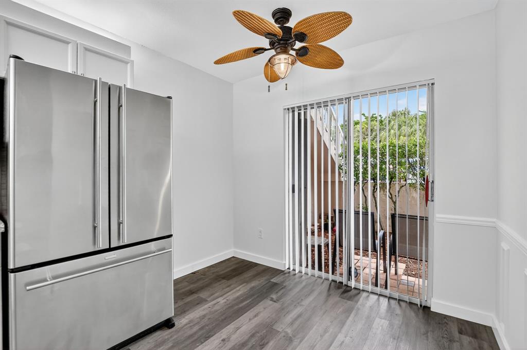 260 Northwest 67th Street, Unit A104 Boca Raton, FL 33487 - Photo 7 of 43 a view of an empty room with wooden floor and a window