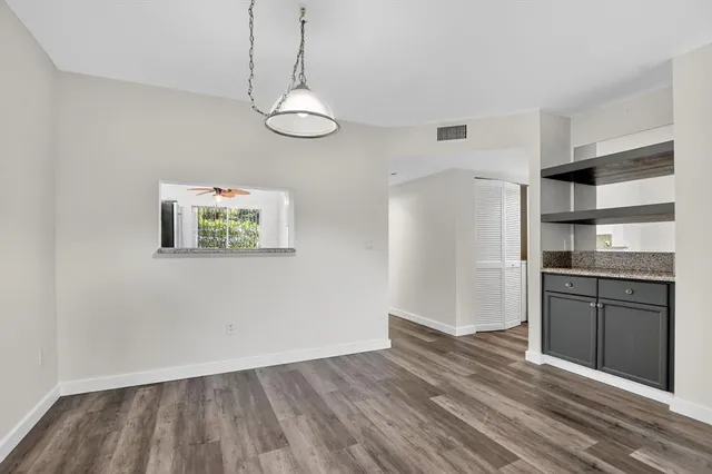 a view of a kitchen with a refrigerator cabinets and wooden floor