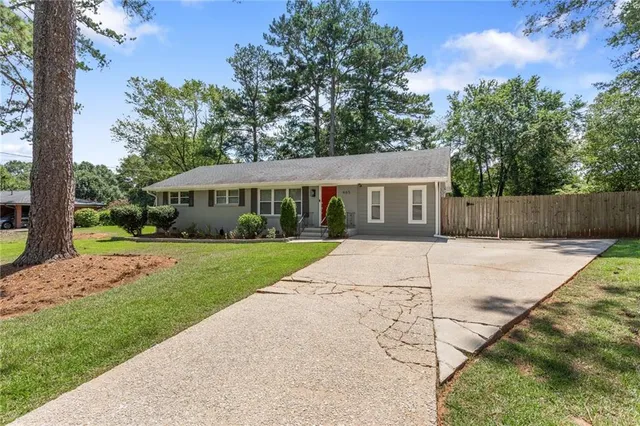 a view of house with yard
