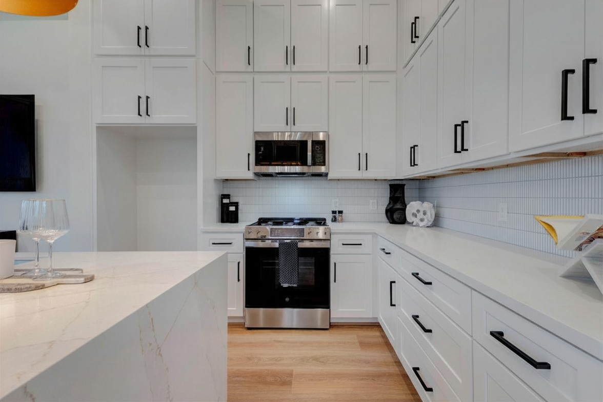 3309 St Emanuel Street Houston, TX 77004 - Photo 5 of 47 Elegant quartz island with overflow, soft-close drawers, and genuine tile backsplash.