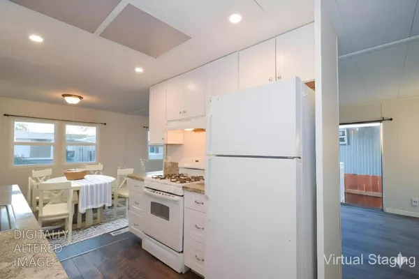 a white refrigerator freezer sitting inside of a kitchen