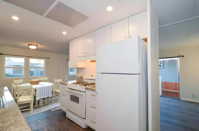 a kitchen with stainless steel appliances a refrigerator and a stove