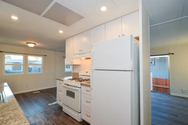 a white refrigerator freezer sitting in a kitchen
