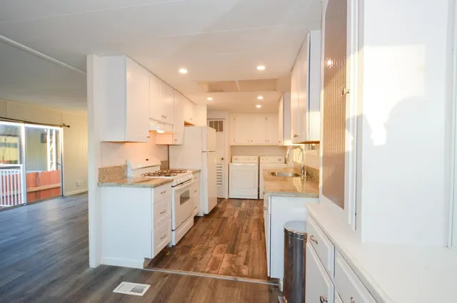 a large kitchen with a large counter top appliances and cabinets