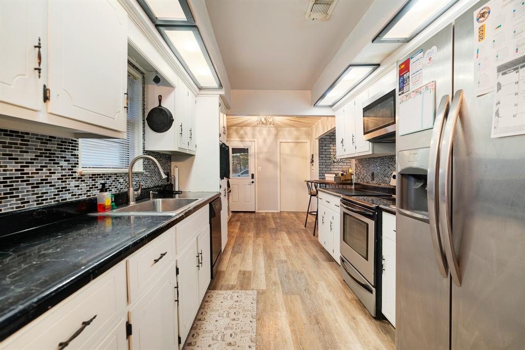 333 County Road Powderly, TX 75473 - Photo 15 of 15 a kitchen with stainless steel appliances granite countertop a sink and a stove
