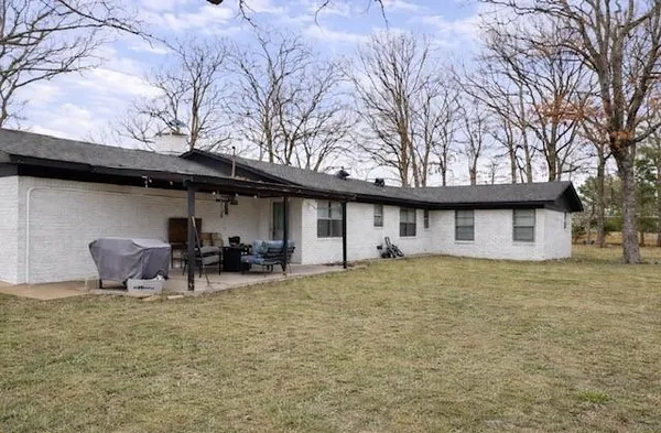 a backyard of a house with table and chairs