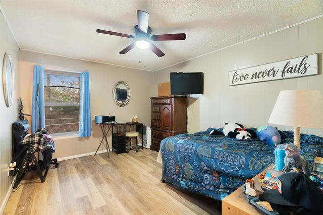 a bedroom with a bed and wooden floor