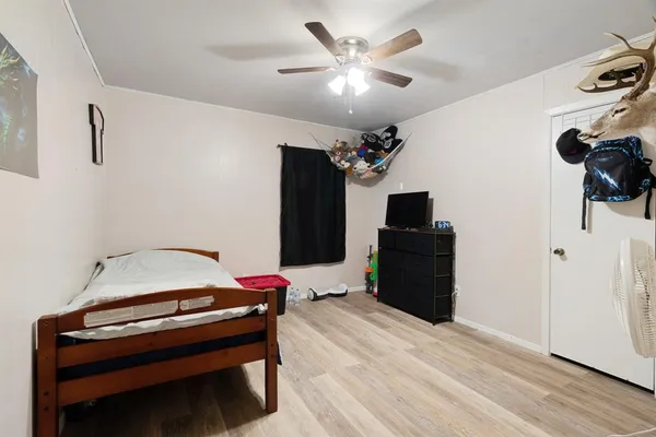a bedroom with a bed and a flat screen tv