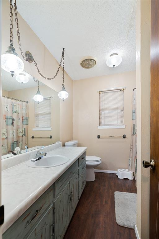 333 County Road Powderly, TX 75473 - Photo 10 of 15 a bathroom with a sink a toilet and a mirror