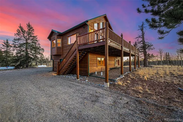 a view of wooden house with a wooden fence