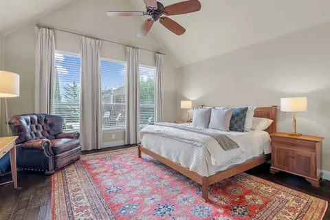 a bedroom with a bed couch and window