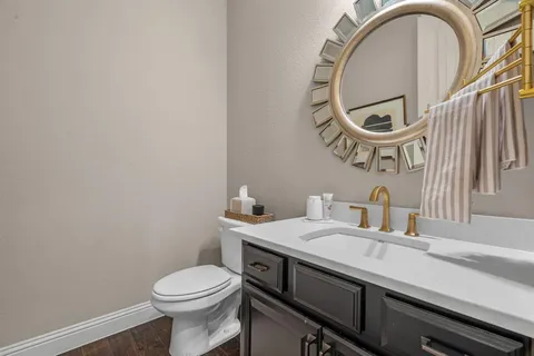 a bathroom with a sink a mirror and a toilet
