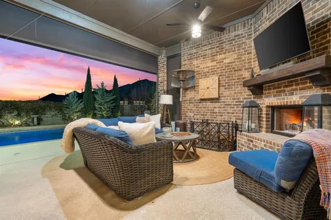 a balcony with furniture and a flat screen tv