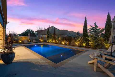 a view of swimming pool with outdoor seating and city view