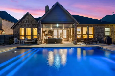a large pool with table and chairs