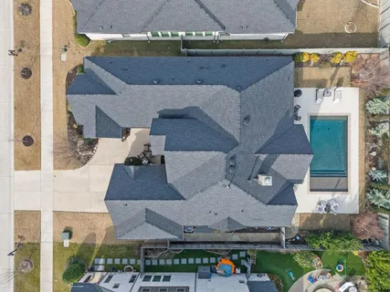 an aerial view of a house with yard