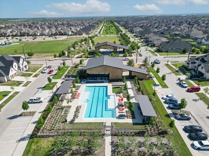 an aerial view of a house with a yard basket ball court and outdoor seating