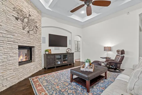 a living room with furniture a rug and a fireplace