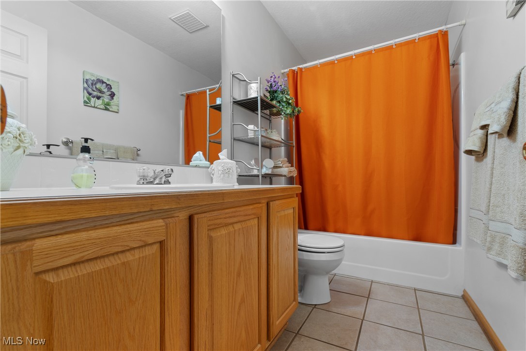 889 Martin Road Mogadore, OH 44260 - Photo 20 of 33 Full bath with vanity, tile patterned flooring, and shower / bath combo