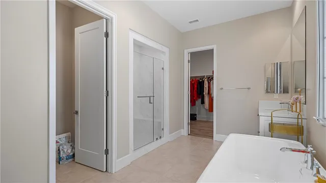 a bedroom with bed and wooden floor