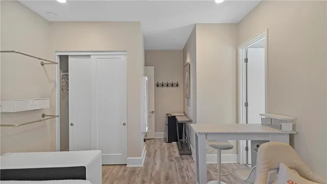a utility room with wooden floor washer and dryer